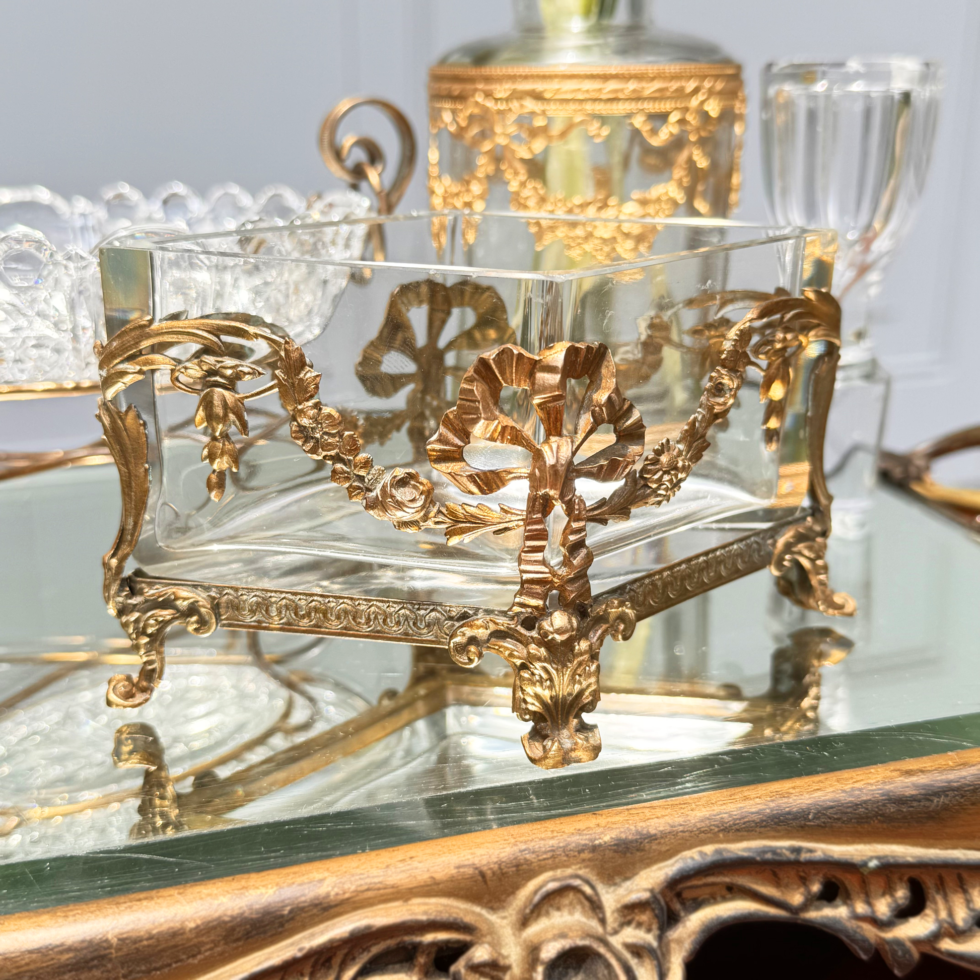 Antique mini brass-mounted crystal jardinière with diamond-shaped crystal insert, front angled view, placed on mirrored surface