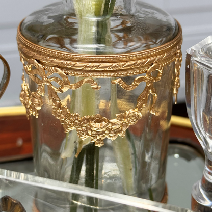 Close-up of antique ormolu mounting featuring roses, swag, and bow details