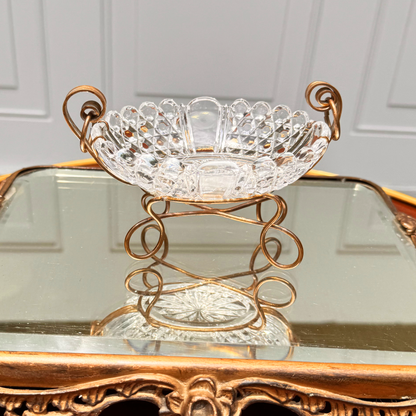 Antique Baccarat crystal catchall, view from slightly above showing brass spiral mounting detail and the crystal edge and details, placed on mirror surface
