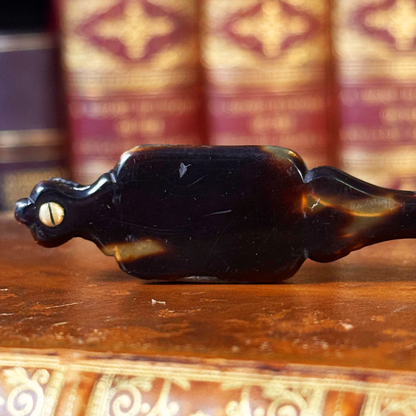 An antique folding lorgnette and spectacles shown folded close-up of backside of handle