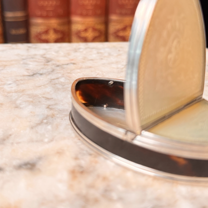 An antique oval tortoiseshell, mother-of-pearl, and silver snuff box, shown open highlighting the tortoiseshell inside