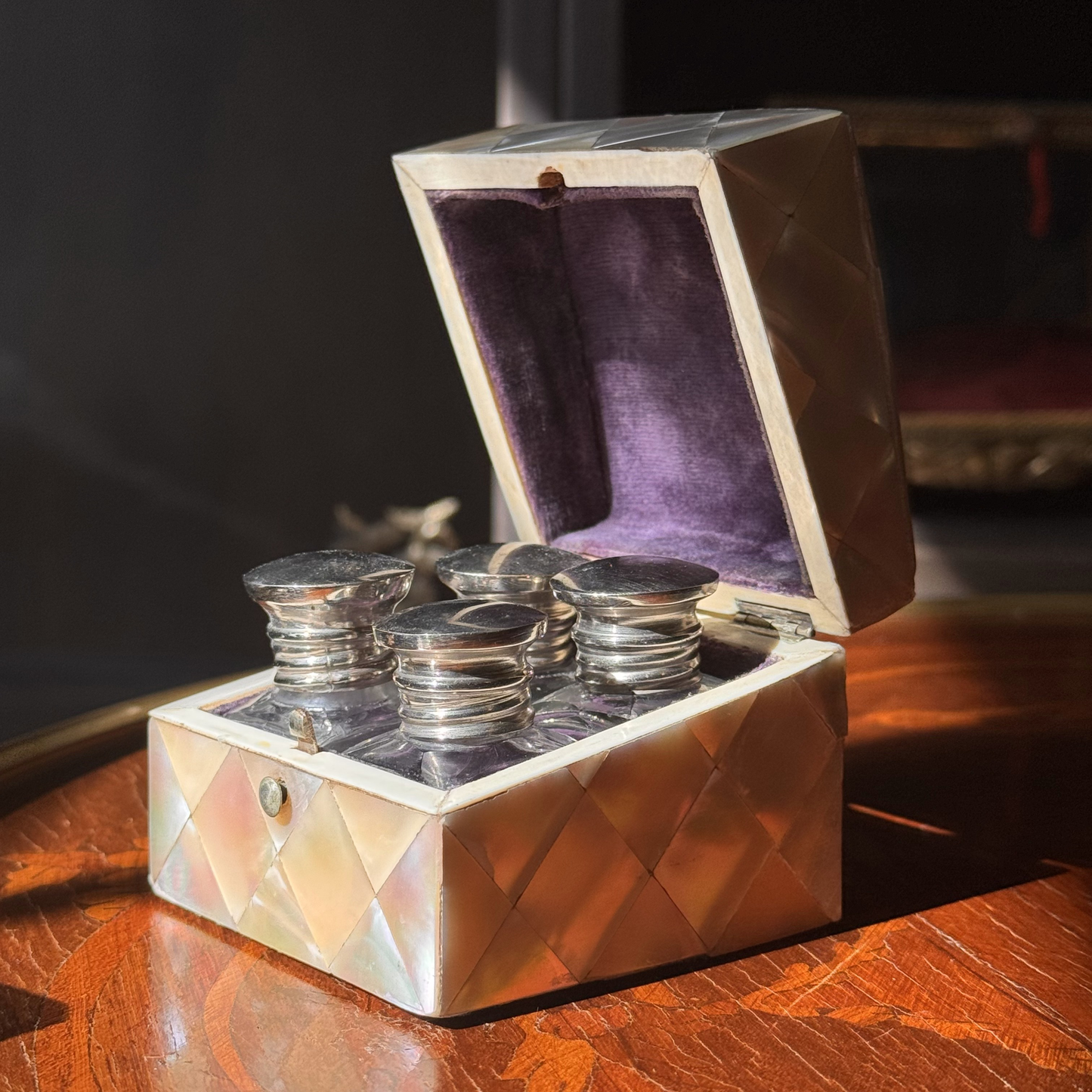 Decorative box with silver items on a wooden surface