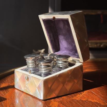 Decorative box with silver items on a wooden surface