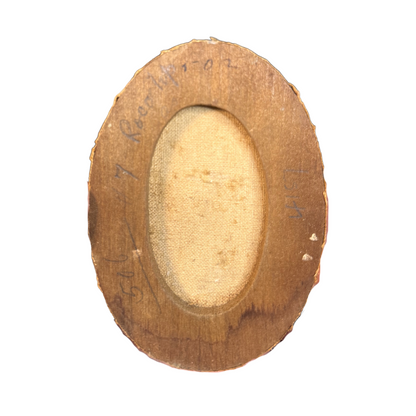 Wooden back of oval frame. Canvas shows through the opening at back. Illegible pencil text on wood.