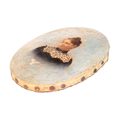 Small oval portrait of a woman on a canvas surface.