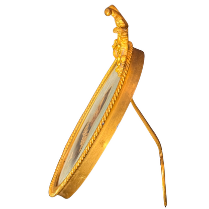 Gold decorative frame with intricate design on a white background. Side view